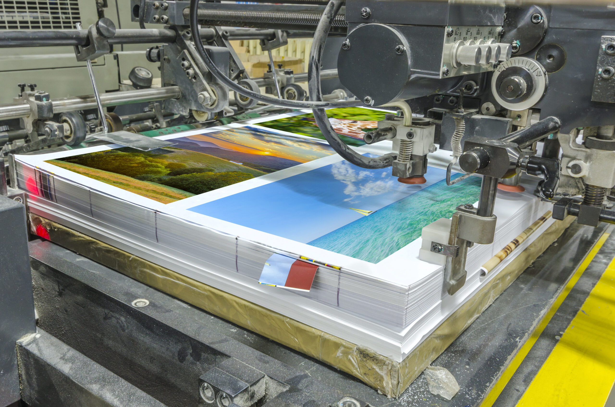 A printing press features stacked sheets